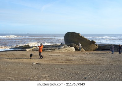 Spurn Head, Yorkshire, UK 01 30 2022 Dog Walkers On A Beach