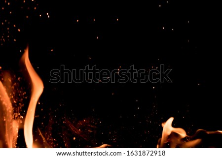 Spurts of flame with sparks on a perfect black background. Great for overlay usage.