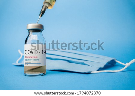 Sputnik V vaccine concept and background for Coronavirus. New vaccine sputnik-v isolated on blue background. Covid-19, 2019-nCov pandemic.