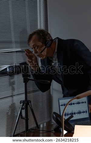 A spy with a headset and a camera peeks through the window for covert surveillance.