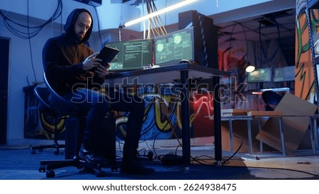 Spy looking on tablet, doing international espionage warfare on other countries for his government, anxiously looking around hideout to not get caught, wary of being uncovered