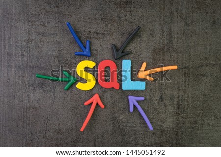 SQL modern programming language for database in software development or application concept, multi color arrows pointing to the word SQL at the center of black cement chalkboard wall.