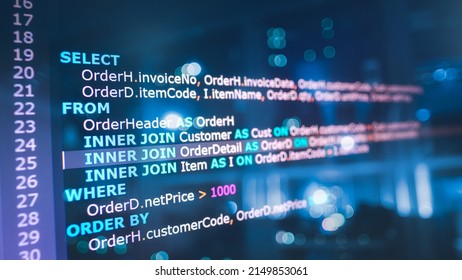 SQL (Structured Query Language) code on computer monitor and server room background. Example of SQL code to query data from a database. 