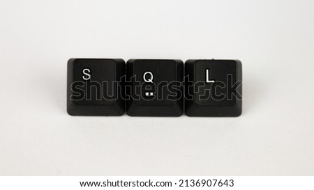Sql text created with keyboard keys isolated on white background, computer terminology, white sql on black keyboard, top view