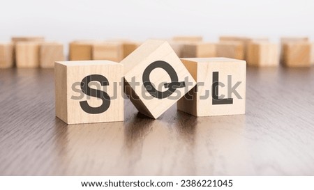SQL text on wooden cubes. wooden background. foreground