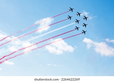 Squadron of planes fly with color trail lines of Poland Singapore Peru Monaco Malta Latvia Indonesia Denmark Austria over clouds and clear sky