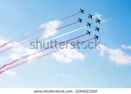 Squadron of planes fly with color trail lines of Poland Singapore Peru Monaco Malta Latvia Indonesia Denmark Austria over clouds and clear sky