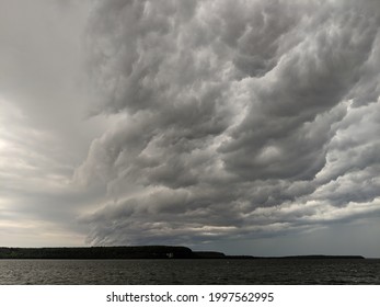 Squall line storm rolling in over a lake.