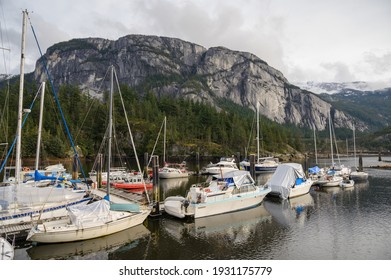 Squamish British Columbia, Canada - March 6th, 2021:  The Squamish yacht club, along the Squamish waterfront, with the Stawamish Chief in the background.  