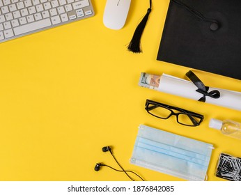 A square academic cap, keyboard, mask, headphones, mouse, disinfectant and certificate with money are located in a semicircle on the right on a yellow background with space for text on the left, top v