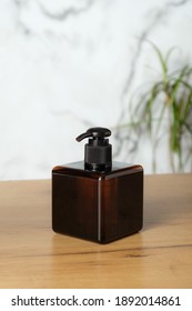 Square Amber Glass Pump Bottle Mockup On Table In Bathroom. Elegant Soap Dispenser Packaging Design.