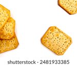 Square biscuits isolated on white background. Heap of sour cream and onion flavor crackers flat lay with copy space. Salty snack, food texture - top view composition.