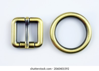 Square Bronze  Buckle With A Flat Tongue And Metal Ring On A White Background. Metal Hardware For The Manufacture Of Belts. High Quality Sewing Accessories. Bag Buckle Top View. 