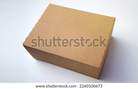 Square cardboard box on a white background.Delivery of parcels. Online order.Craft packaging.