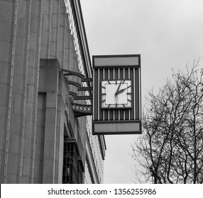 Square clock mounted on a building wall