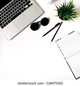 Square Crop. Stylish Minimalistic Workplace With Laptop Keyboard, Notebook, Sunglasses And Office Plant In Flat Lay Style. White Background. Top View.