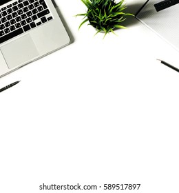 Square crop. White office desk with laptop keyboard and supplies. Laptop, notebook, pen, clips, pencil, plant and office supplies on white background. Flat lay, top view, mockup