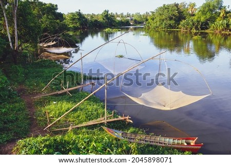 Square dip net for catching the fish as the traditional fishery in Asia, it was hung beside the canal with the small boat, Fish Trap