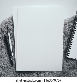 Square format workplace flat lay, top view: pen, pencil, blank page. Motivation for art, drawing, sketching. Hygge style, monochrome stationary. Photo with place for text, copy space.