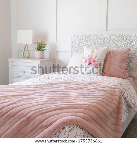Square frame Bedroom interior with floral feminine beddings and decorative headboard on bed