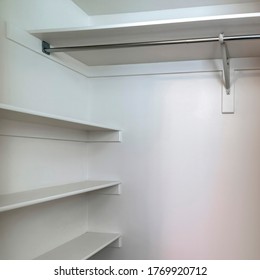 Square Frame Empty Walk In Closet Of New Home With Wall Shelves And Hanging Clothes Rod