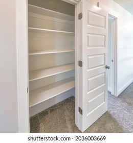 Square Frame Linen Closet Of House With Wide Shelves For Storing Organization And White Door