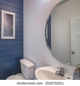 Square Frame Powder Room Interior With Blue Wooden Planks Front Wall And Frames