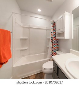 Square Frame White Bathroom With Wall Cabinet And Colorful Shower Curtain