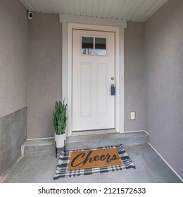 Square Front Door Exterior With Potted Plants And Decorative Doormat At The Doorsteps