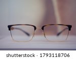 Square glasses with brown frames close up on a store shelf