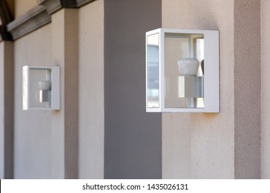 Square Hinged Lantern On The Wall In An Iron Case With A Glass And A White Lamp.