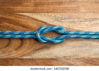 Square Knot. Nautical Rope Knot On Wooden Background