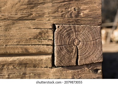 Square Old Pine Log Timber Constructed House Cabin Corner Dovetail Joint Closeup. Rustic Wood Structure. Raw Textured Surface. Contrast Daylight.