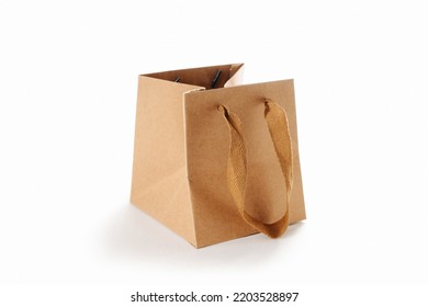 Square Paper Bag With Cloth Handles, Partially Folded. Over White Background.