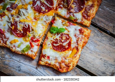 Square Pepperoni Pizza On Rustic Wooden Background