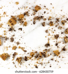 A Square Photo Of A Frame Made Up By Chocolate Chips Cookie Crumbs, Shot From Above On A White Marble Background, With A Place For Text