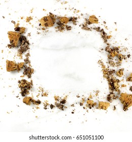 A Square Photo Of A Frame Made Up By Chocolate Chips Cookie Crumbs, Shot From Above On A White Marble Background, With A Place For Text