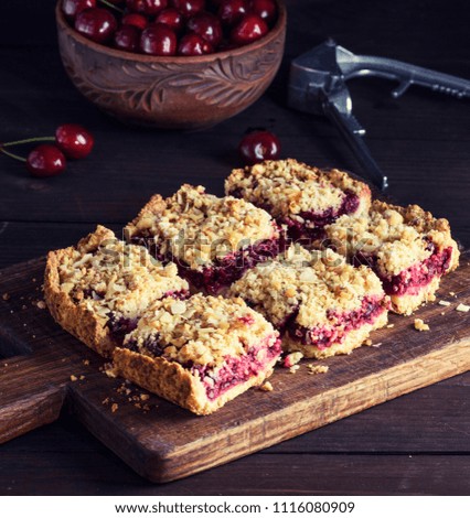 Similar – square pieces of cake crumble with cherry