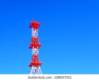 Square rectangle big red white steel beam structure telephone radio masts telecommunication antenna tower architecture on clear gradient blue sky with right blank space