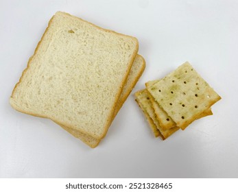 Square shaped crispy biscuits and plain breads. Delicious snack isolated white background - Powered by Shutterstock