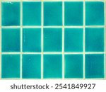 Square shaped green glazed tile wall.