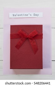 Square shaped Valentines gift under adhesive note 