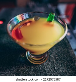 A Square Shot Of Gummy Worms In A Cocktail With Orange Juice 