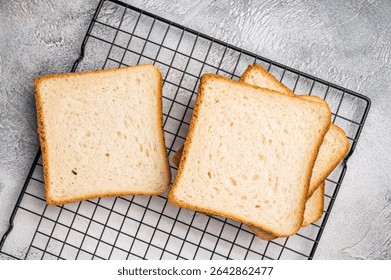 Square Slices of loaf wheat bread for toasts. white background. top view.