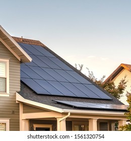 Square Solar photovoltaic panels on a house roof - Shutterstock ID 1561320754