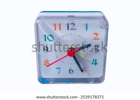 Square table clock with alarm clock, small electronic bedside compact alarm clock, quartz tabletop isolate close-up.