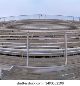 Square Tiered Seating At A Sports Arena Under A Cloud Filled Sky In Winter