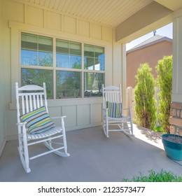 Square Two White Rocking Chairs With Striped Pillows On A Porch Of A House