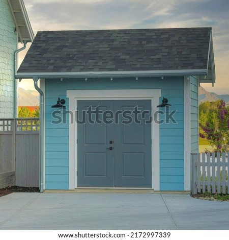 Square Whispy white clouds Light blue storage shed outside a house at Daybreak, Utah
