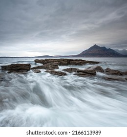 Squarer format long exposure photograph capturing an incoming wave at Elgol on the Isle of Skye 